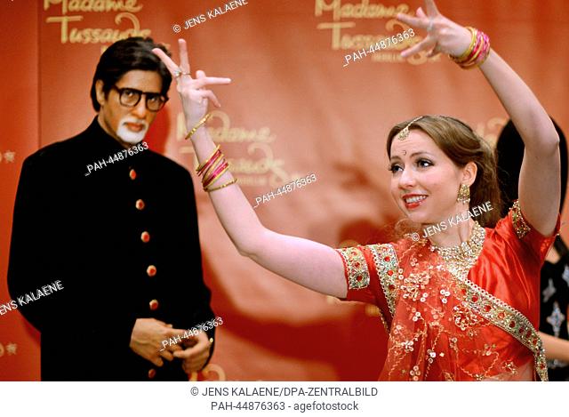Dancers of the Bollywood dance group 'Rang De by Zaraa Vi' present the wax figure of Bollywood star Amitabh Bachchan at the Indian embassy in Berlin, Germany