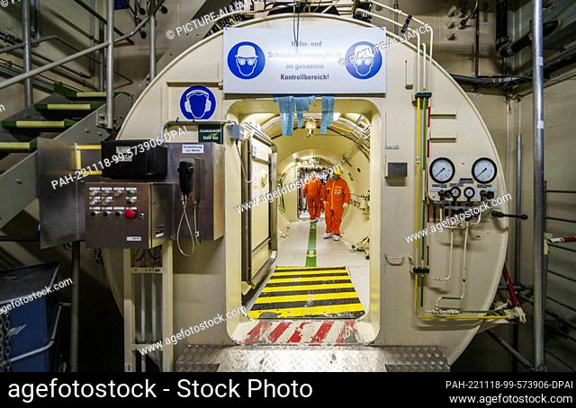 18 November 2022, Hessen, Biblis: People walk through an airlock in a power plant unit. The Biblis nuclear power plant has been undergoing decommissioning since...