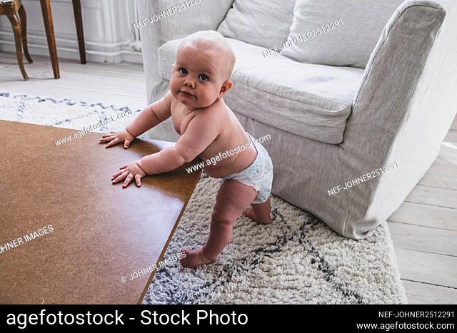 Baby standing at table