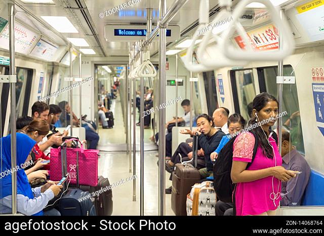 SINGAPORE - JAN 13, 2017: Passengers in Singapore Mass Rapid Transit (MRT) train. The MRT has 102 stations and is the second-oldest metro system in Southeast...