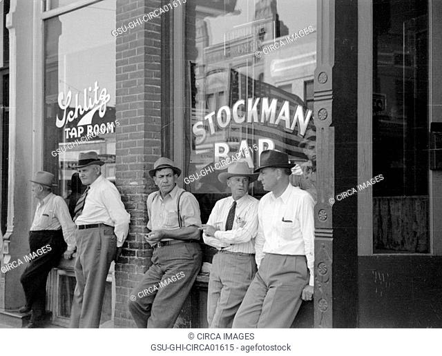 Stockmen in Front of Bar, Main Street, Miles City, Montana, USA, Arthur Rothstein for Farm Security Administration, June 1939