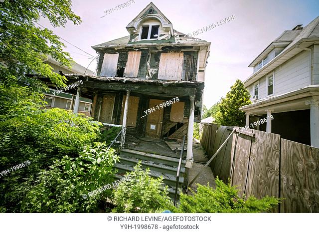 Dilapidated home in the Flatlands neighborhood of Brooklyn in New York. After being damaged by squatters and a fire the city is deciding whether to tear down...