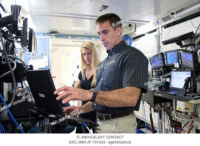 NASA astronauts Chris Cassidy, Expedition 3536 flight engineer; and Karen Nyberg, Expedition 3637 flight engineer, participate in a robotics training session in...
