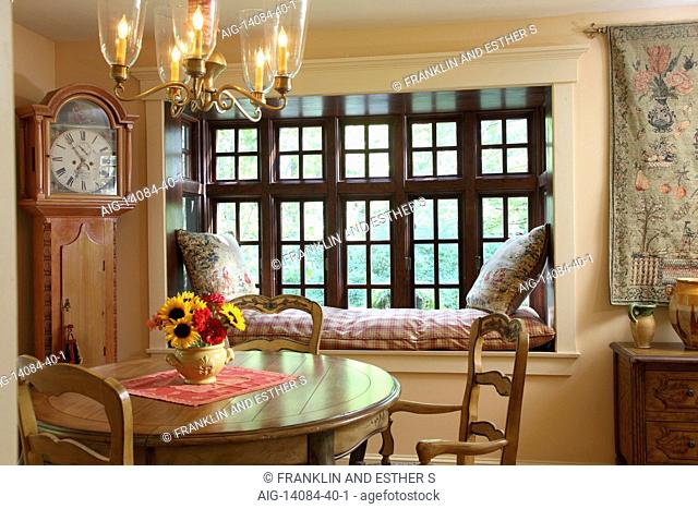 Cozy and romantic dining room, with window seat and grandfather clock, USA
