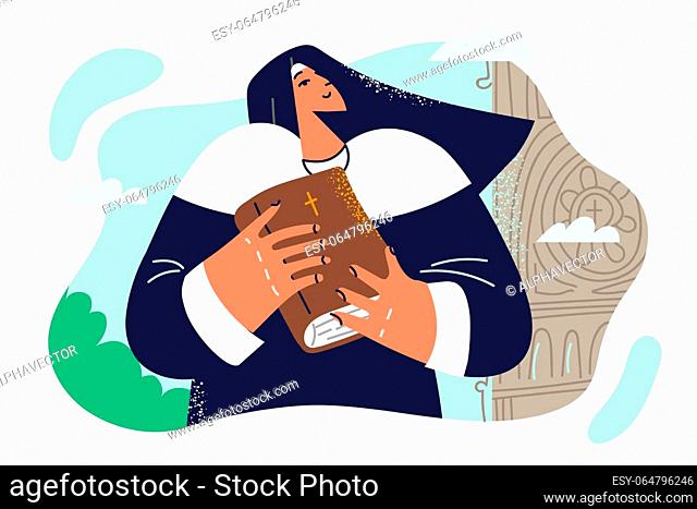 Woman nun with bible stands near cathedral and invites parishioners to attend sunday worship. Female nun in catholic cassock serves in church and learns sacred...