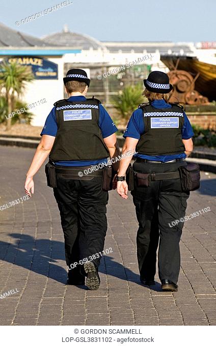 England, City of Brighton and Hove, Brighton. Two female Police Community Support Officers patrolling Brighton seafront