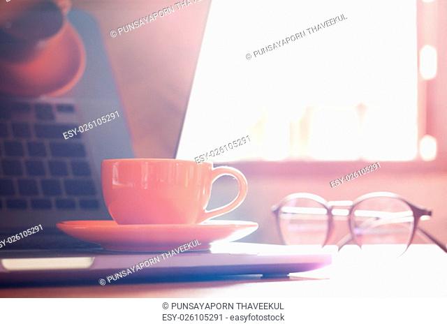 Coffee cup with keyboard on wooden table, stock photo