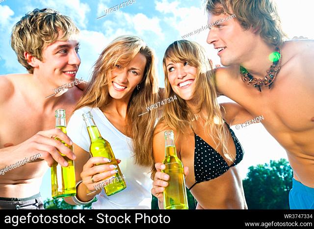 Group of very beautiful people celebrating on the beach in the summer of their lives