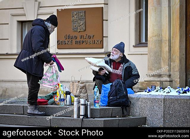 Activist and former dissident John Bok, left, and former dissident Jiri Gruntorad pack supplies and equipment after he and ended their hunger strike in front of...