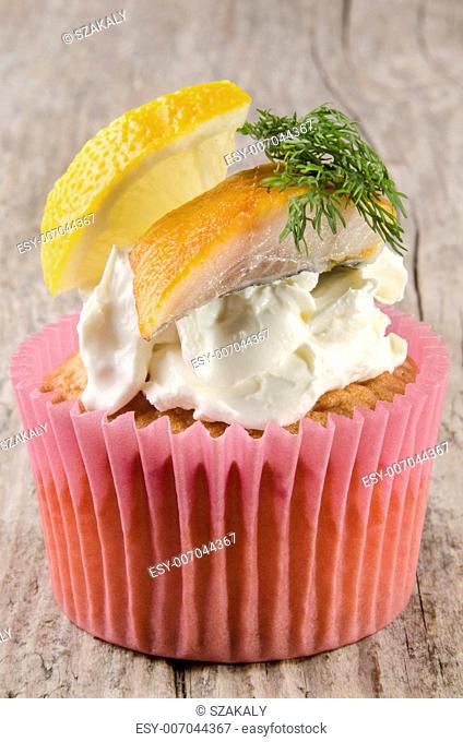smoked trout on a cupcake with soft cheese, dill and lemon