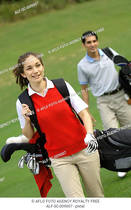 Female golfer walking down the fairway