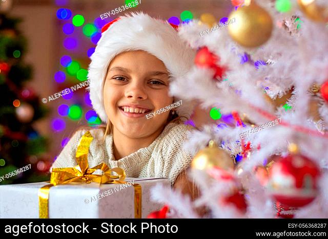 Portrait of a close-up of a beautiful girl with a New Year's gift