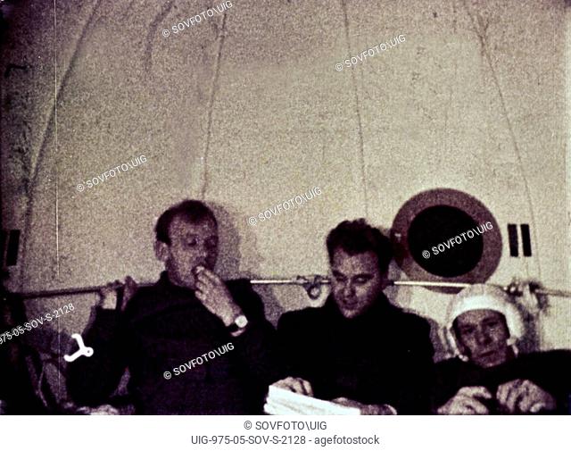 Cosmonauts vladimir shatalov, evgeni khrunov, alexei eliseyev, and boris volynov eating dinner aboard soyuz 4 after leaving soyuz 5, july 1969