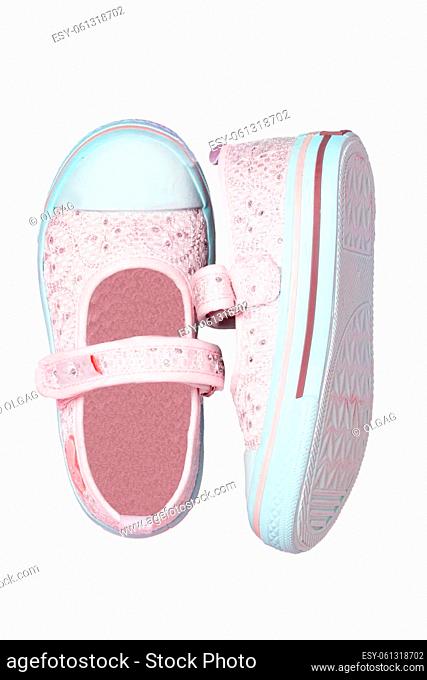 Child shoes fashion. Close-up of a pair pink shoes or sneaker for girls with pearls and hearts isolated on a white background