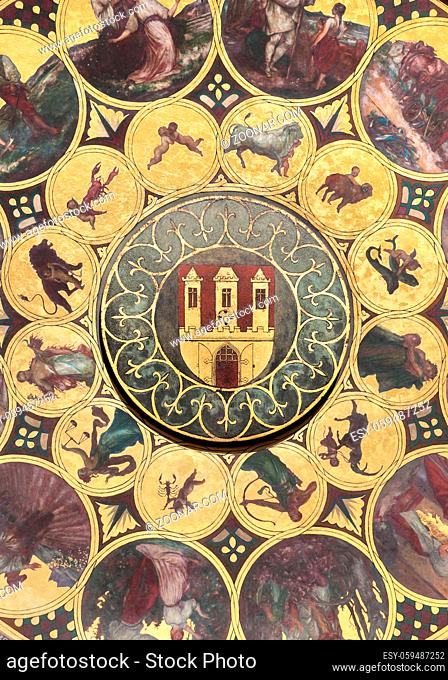 The calendar plate with coat of arms of Prague in the center. Wallpaper background. It is situated below the astronomical clock in Prague, Czech Republic