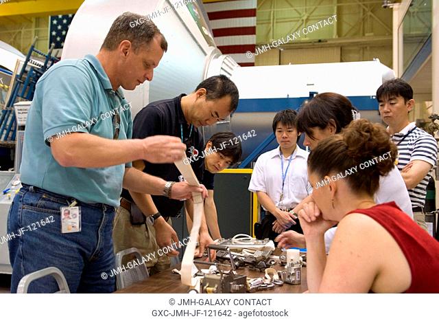 NASA astronaut T.J. Creamer (left) and Japan Aerospace Exploration Agency (JAXA) astronaut Soichi Noguchi (second left), both Expedition 2223 flight engineers