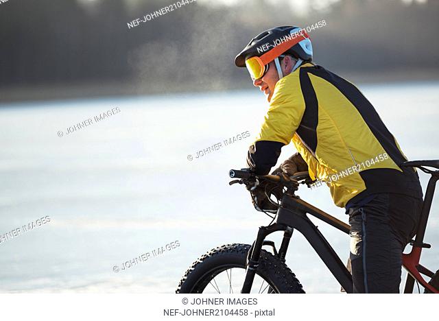 Man cycling on a frozen lake