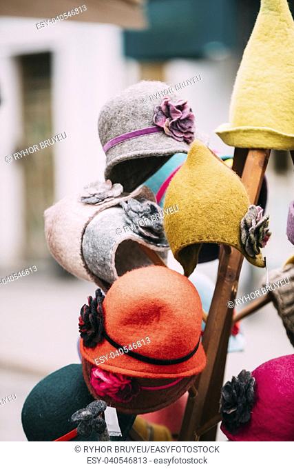 Close View Of Various Colorful Traditional European Caps Hats At Winter Christmas Market. Souvenir From Europe