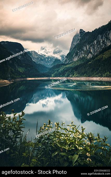 Misty summer morning on the Vorderer Gosausee lake. Colorful sunrise in Austrian Alps, Salzkammergut resort area in the Gosau Valley in Upper Austria, Europe