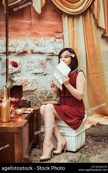 retro girl sitting at a dressing table with a letter in your hands