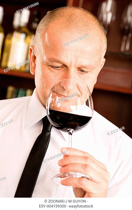 Bar waiter smell glass red wine restaurant