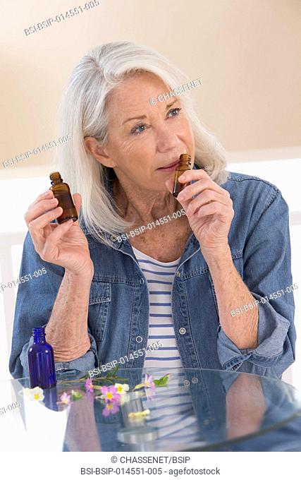 Senior woman smelling essential oils