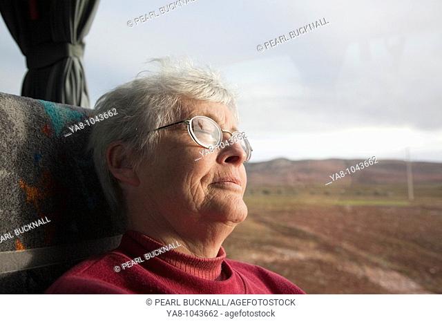 Morocco  Senior woman asleep on coach seat by window MR 08/20