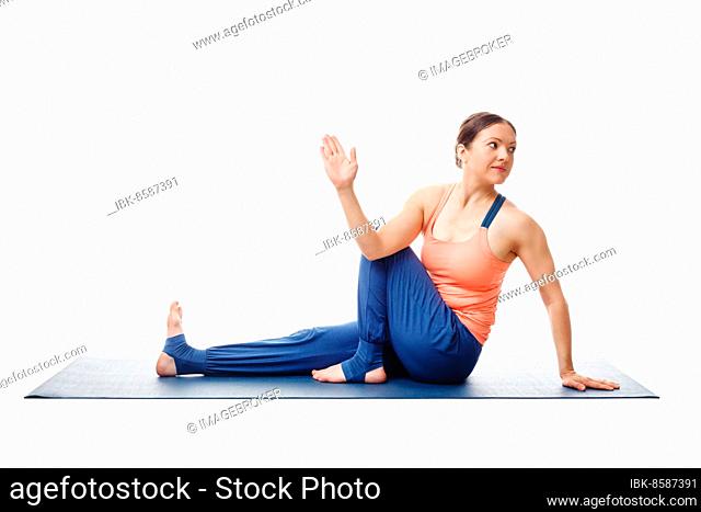 Woman doing yoga asana Ardha matsyendrasana, half spinal twist pose posture isolated on white background