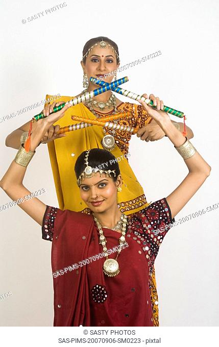 Portrait of two women performing dandiya