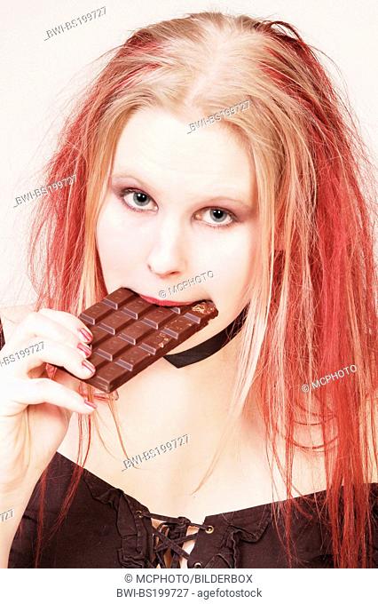 young woman eats chocolate