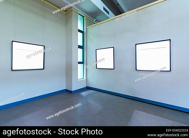 blank frames on exhibition room, fro painting or photography on wall, clipping path included