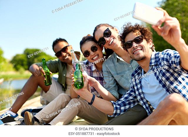 friends with drinks taking selfie by smartphone