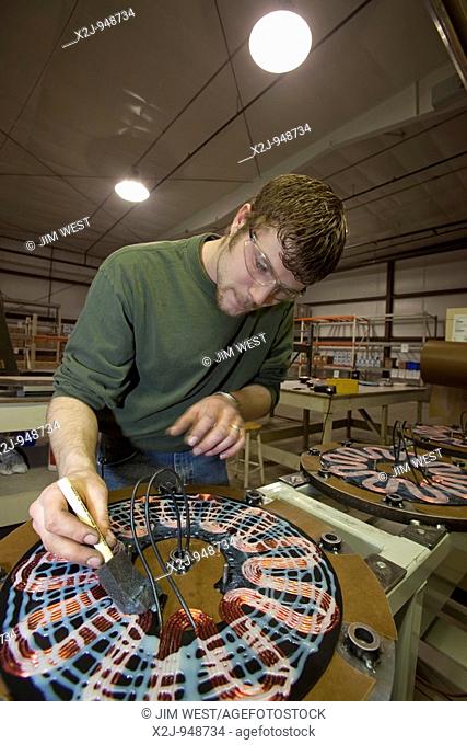 Manistee, Michigan - Workers assemble the electrical components of Windspire wind turbines  The Windspire is a small, vertical axis wind turbine designed for...