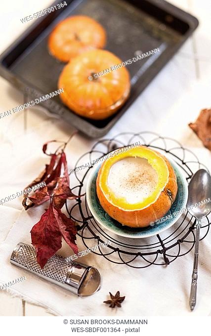 Oven baked mini-pumpkin filled with spiced hot coconut cream