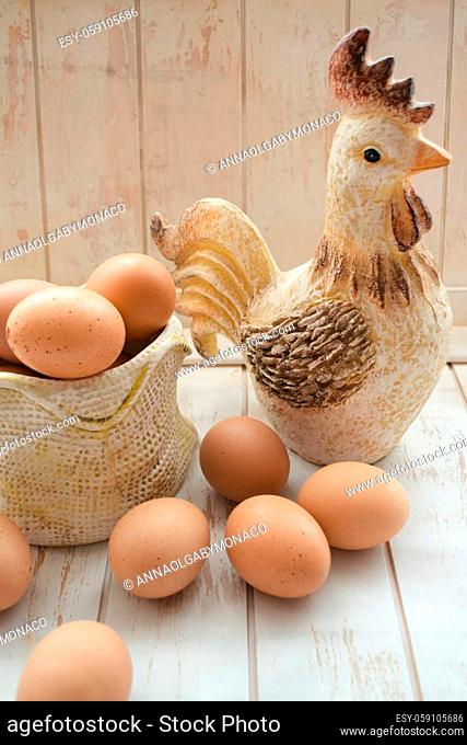 Composition of eggs and rooster toy. Concept of interior decoration for Easter. Vertical image