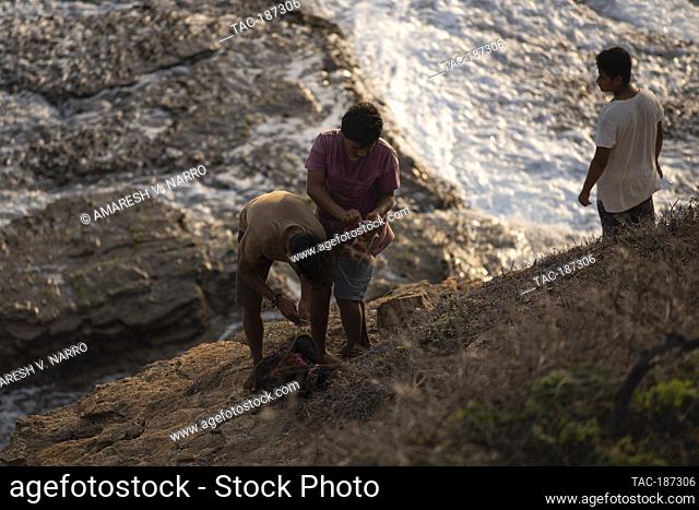 MAZUNTE, MEXICO - JUNE 9: People fishing for mojarras in the mountain at the western end of Mazunte beach known as Punta Cometa (kite tip) on June 9