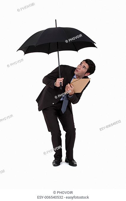 Businessman discovering a hole in his umbrella