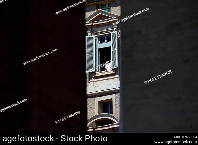 Pope Francis appears from the window of the Apostolic Palace in Saint Preter's Square. The square is empty due to the coronavirus pandemic