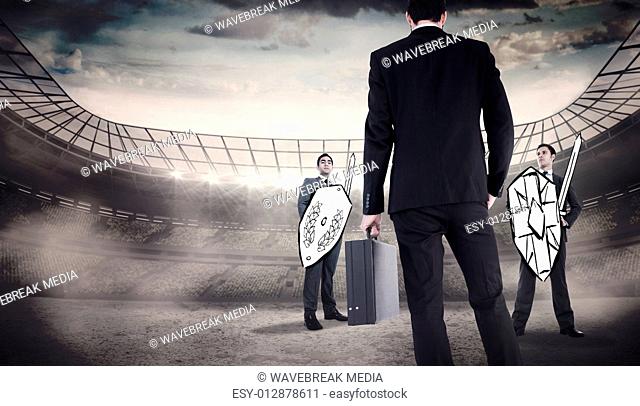 Composite image of rear view of businessman holding a briefcase