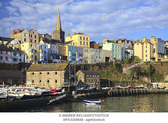 Colourful houses above Tenby Harbour bathed in early morning light, with St Mary's Church carefully position as the main focal point