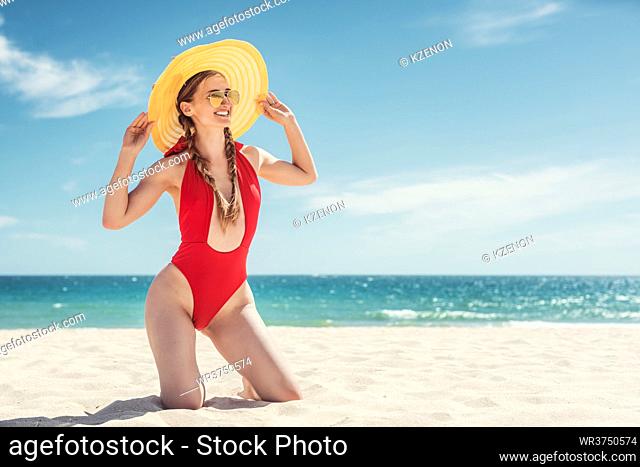 Beautiful woman in her beach vacation with ocean in the background