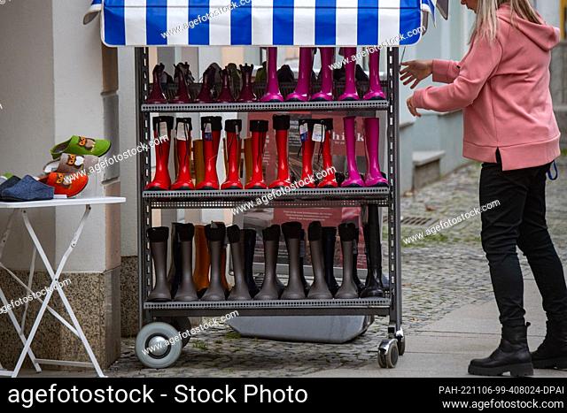 06 November 2022, Mecklenburg-Western Pomerania, Stralsund: Rubber boots are offered for sale in front of a shoe store. The Hanseatic city offered another open...