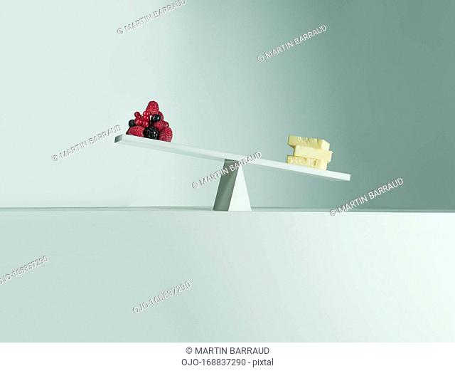 Cheese tipping seesaw with berries on opposite end