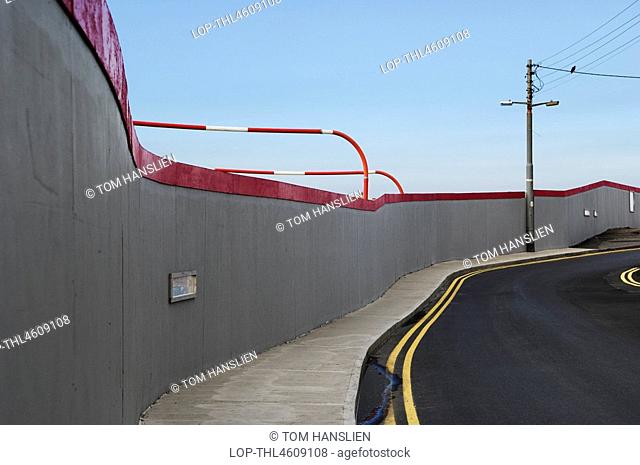 Republic of Ireland, County Wicklow, Greystones, Construction site boarding along a winding road