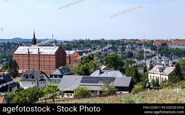 11 August 2022, Saxony, Stollberg: Hoheneck Castle towers prominently among the rooftops of the town of Stollberg. It was once home to the largest women's...