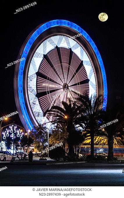 Ferris wheel and moon at the fair in Valencia, Valencian Community, Spain