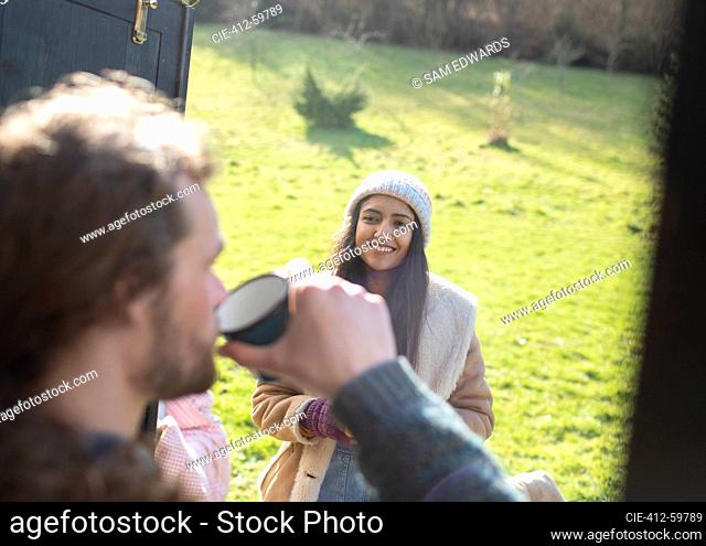 Young couple enjoying coffee at campsite