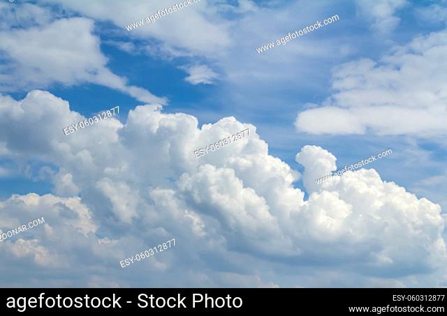 Full frame sky scenery with some sunny illuminated clouds