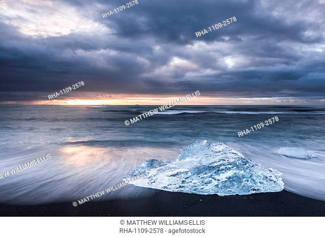 Iceberg at sunrise on Jokulsarlon Beach, a black volcanic sand beach in South East Iceland, Iceland, Polar Regions