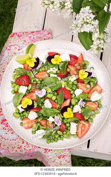 A bean and goat’s cheese salad with strawberries and edible flowers